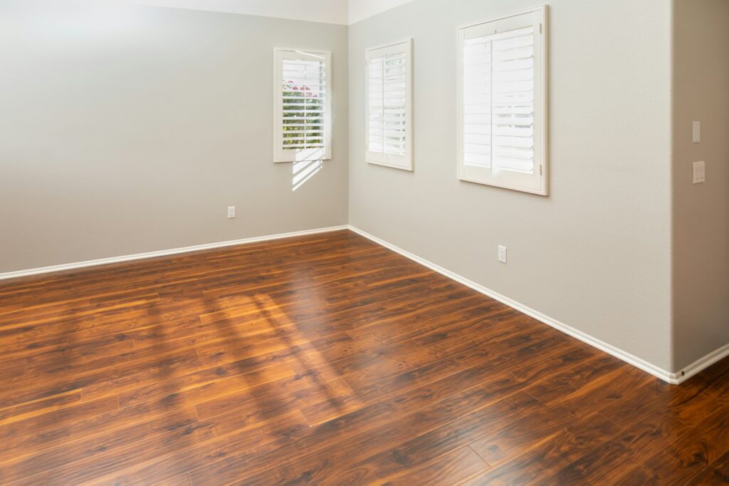 Newly Installed Brown Laminate Flooring and Baseboards in Home